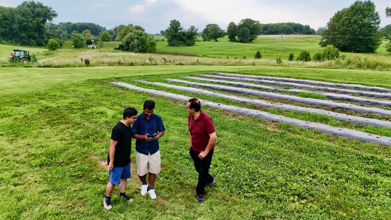 PhD students with supervisor at agricultural field